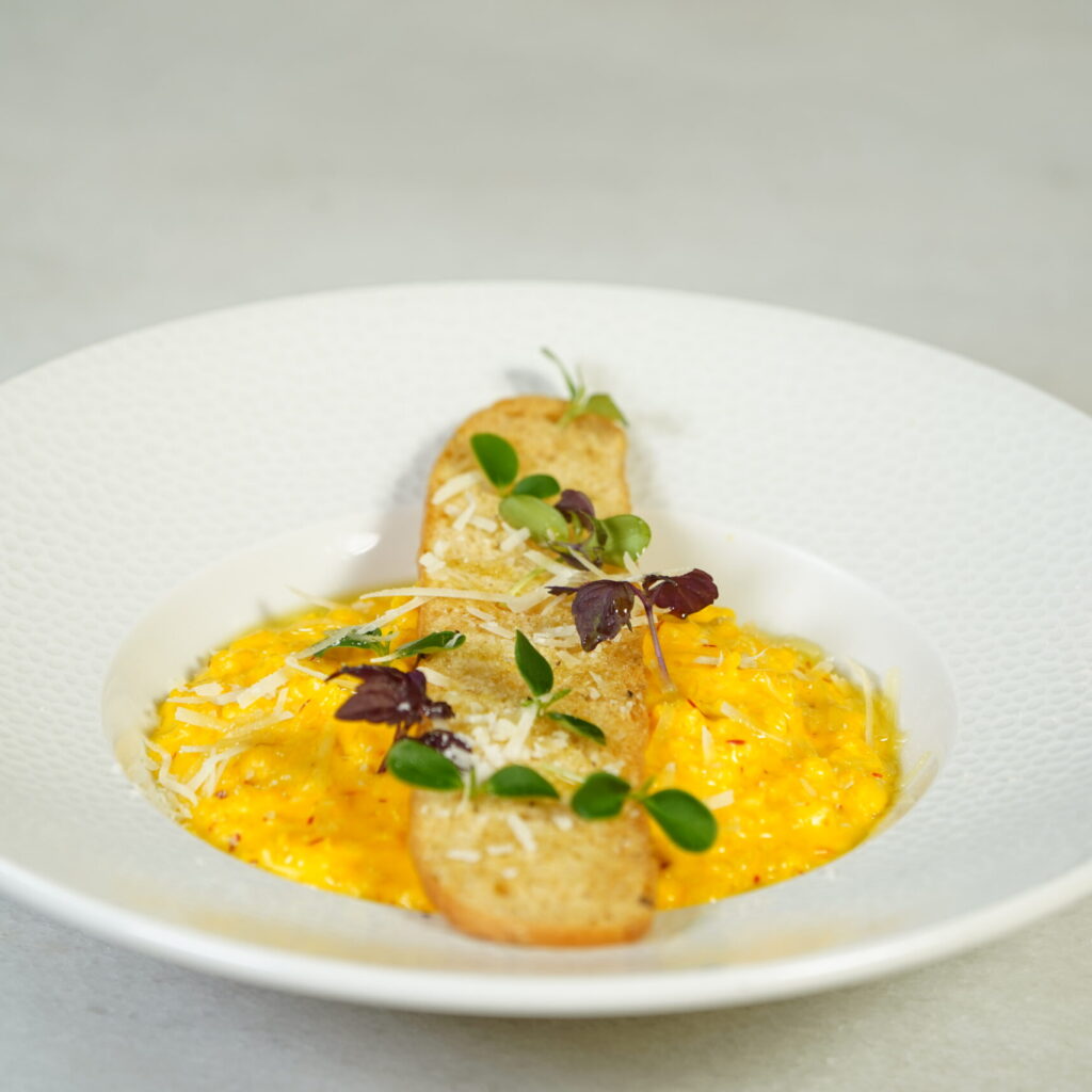 affron risotto garnished with parmesan